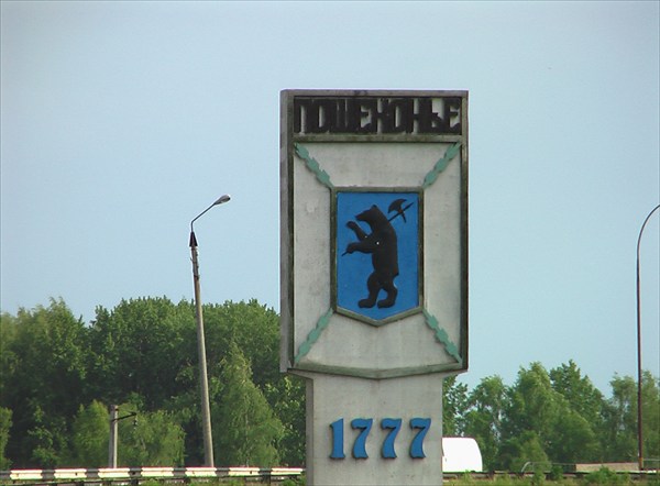 на фото: Герб города на въезде