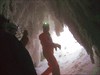 на фото: Ледяные сталактиты на входе