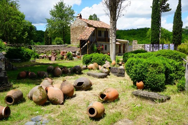 Во дворе разбросаны квеври - сосуды для вина